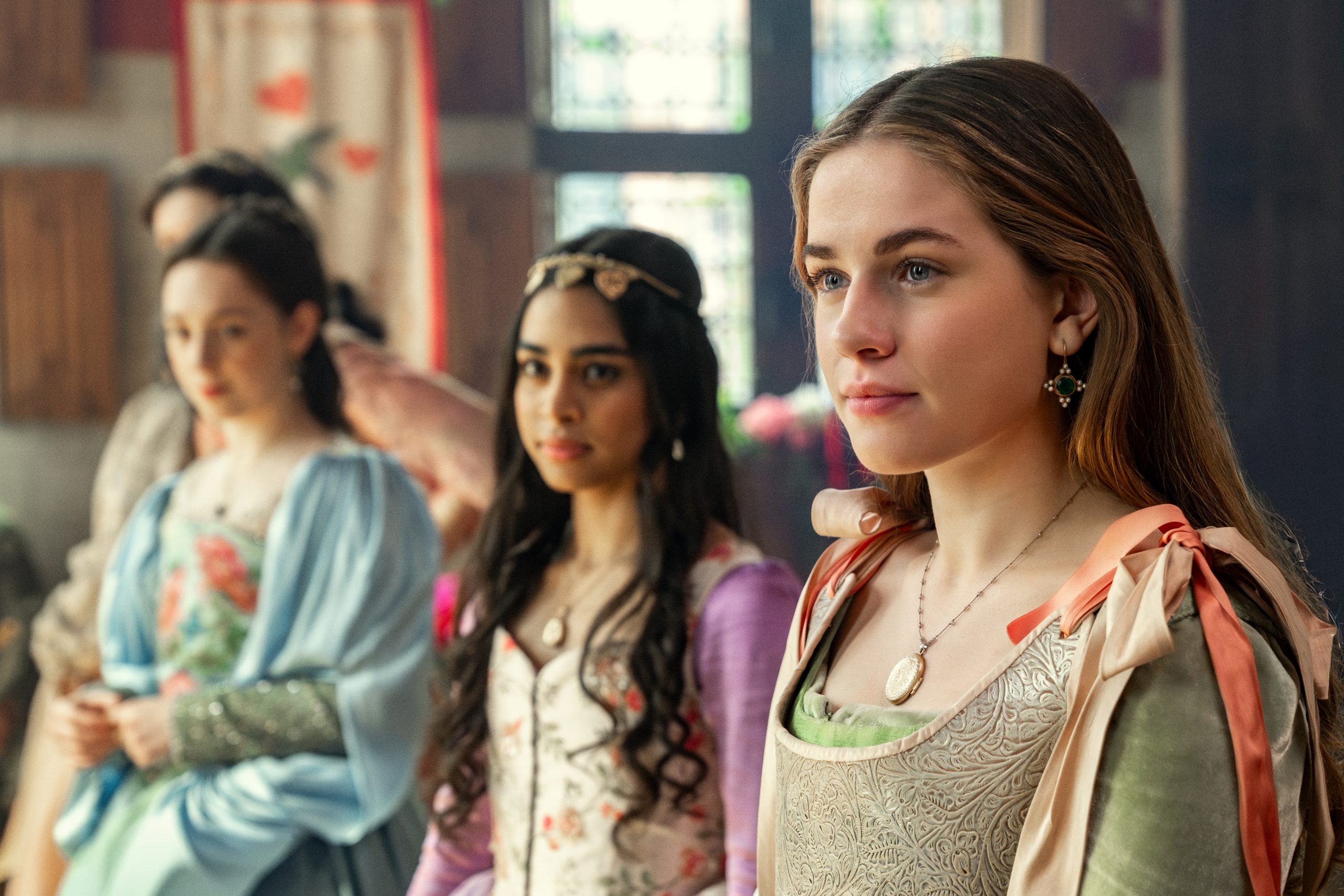 3 girls in period dress looking off camera